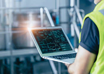 A technician reviewing a control system schematic