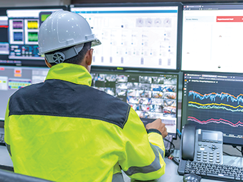 A technician reviewing a control system dashboard